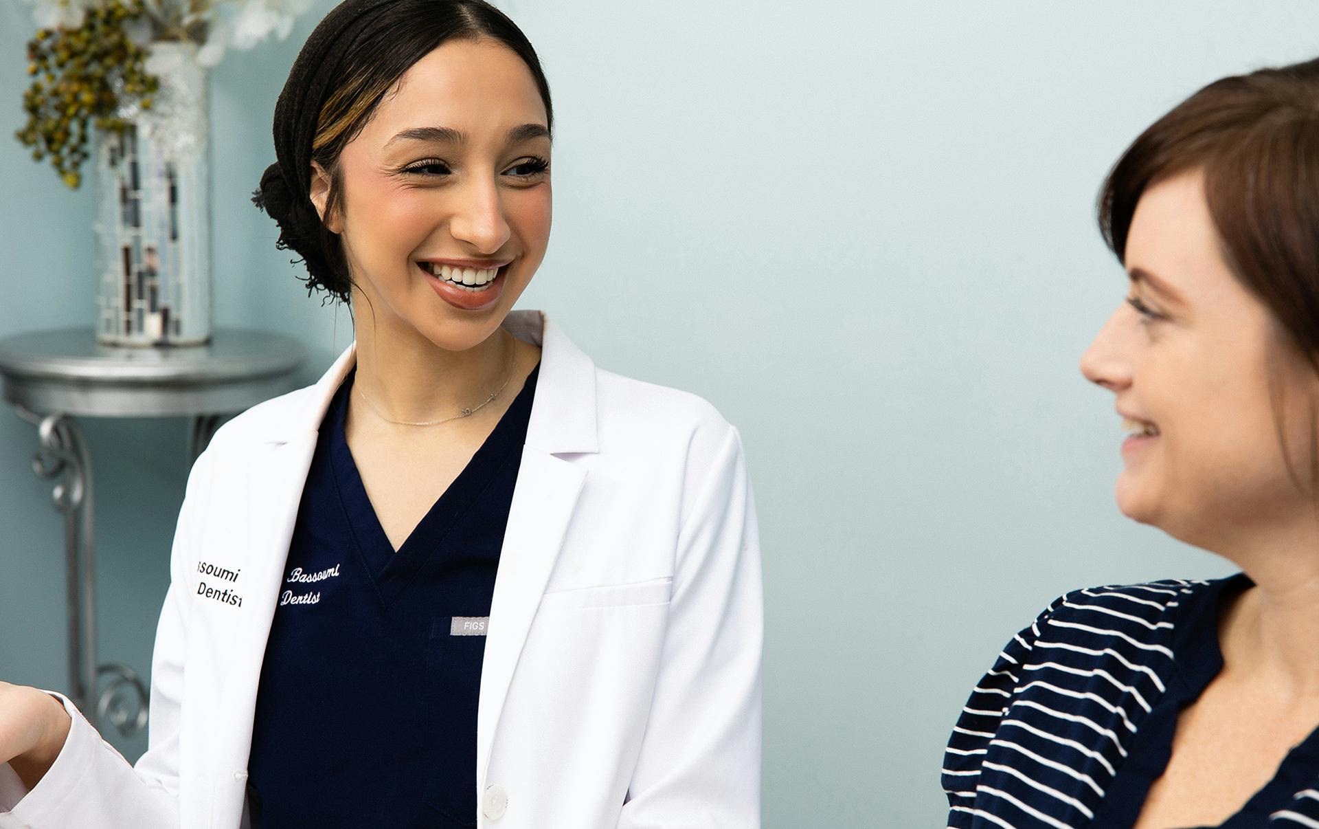 Nurse handing woman a clipboard to fill out