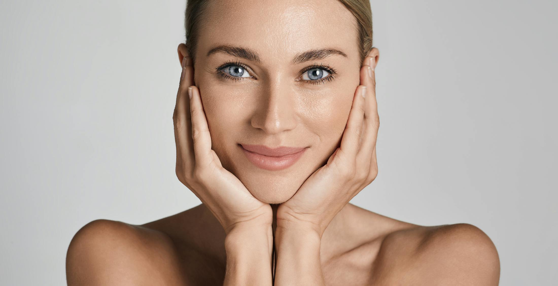 Woman touching her face and smiling