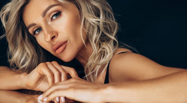 Woman with blond hair and her head titled