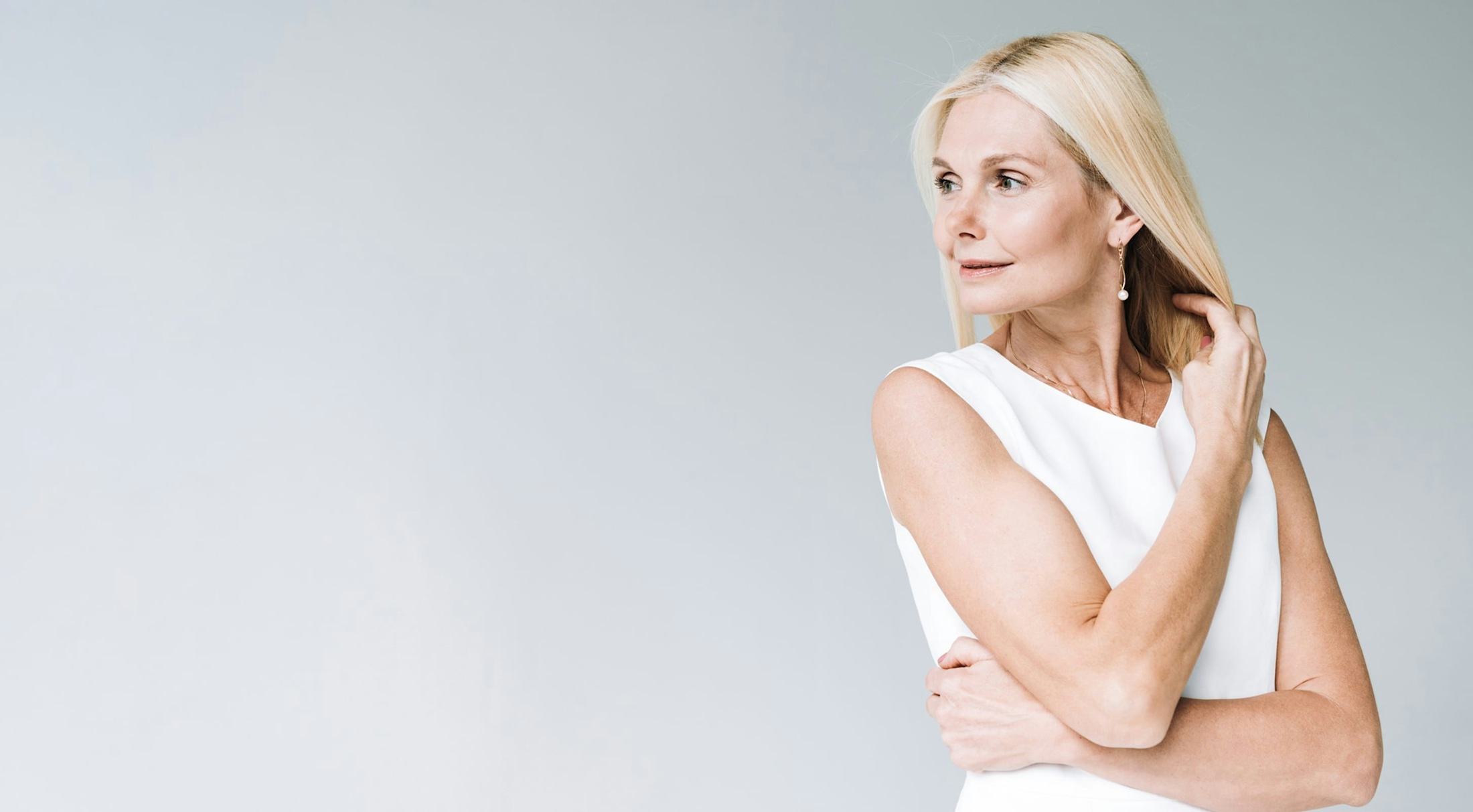 Woman with blond hair looking over her shoulder