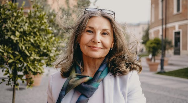 Older woman with glasses on her head