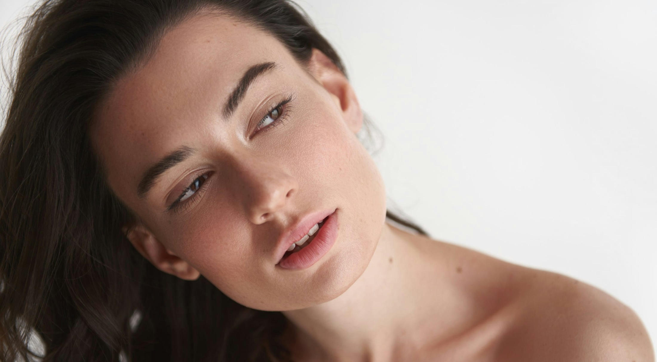 Woman looking to the side with her head tilted