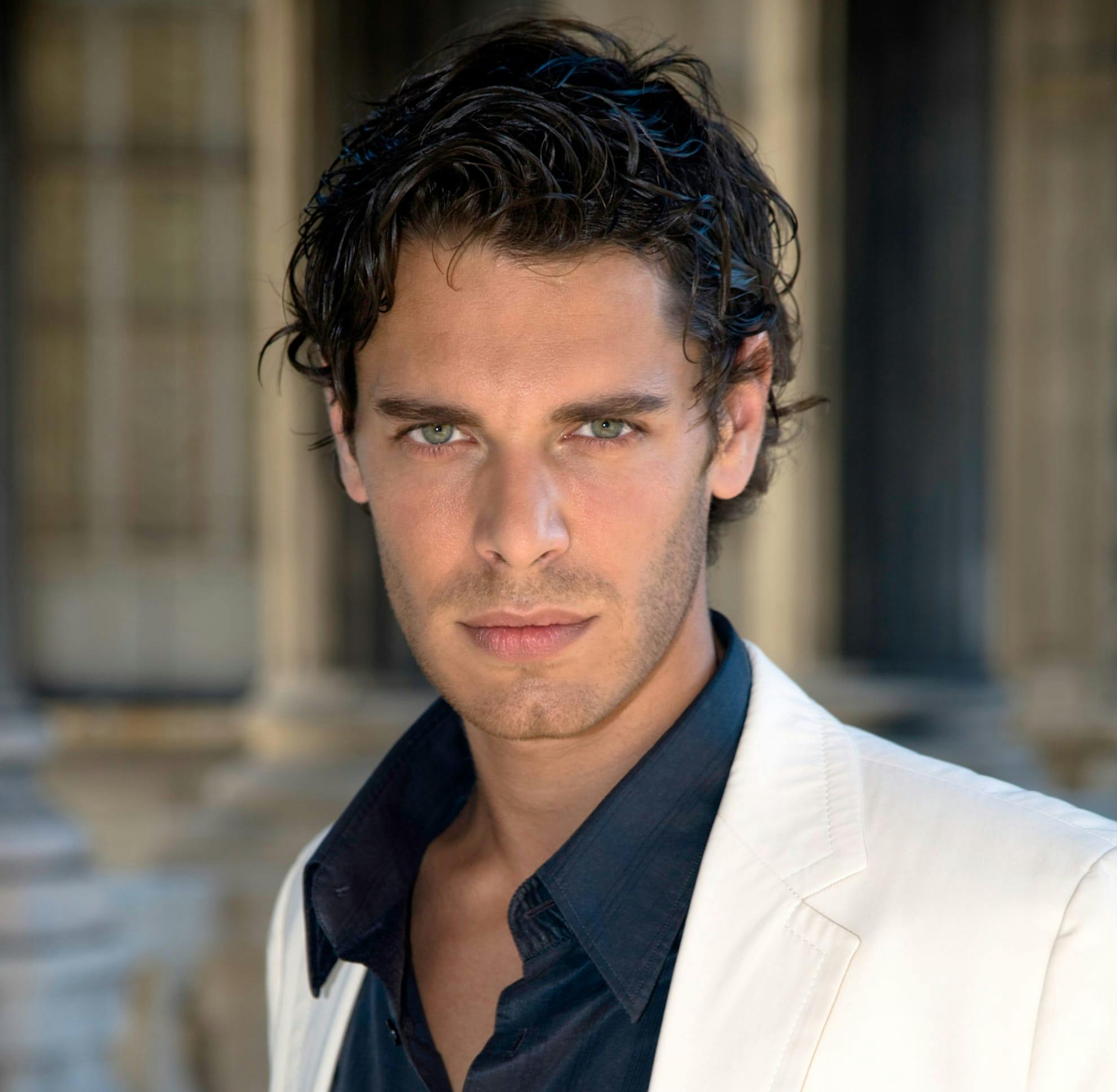 man with a white coat looking intensely at the camera