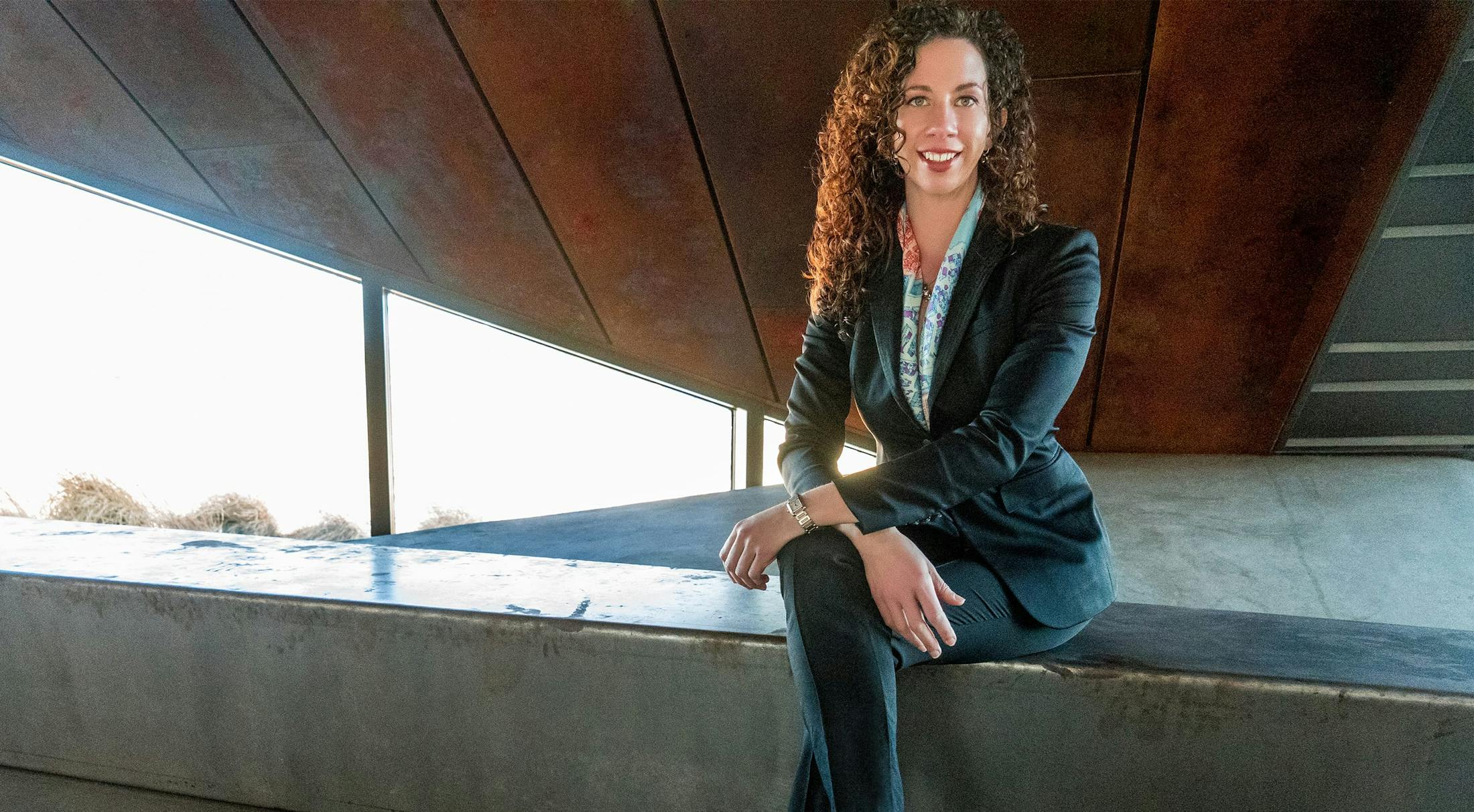 Dr. Koonce sitting on a ledge