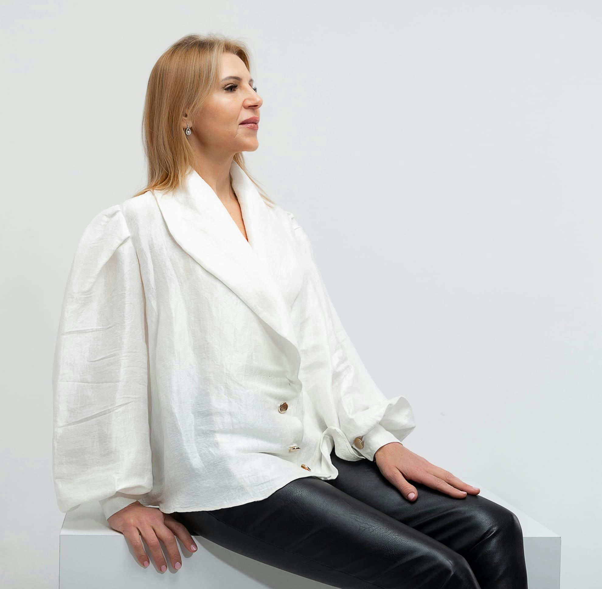 Woman holding her shirt and looking into the camera