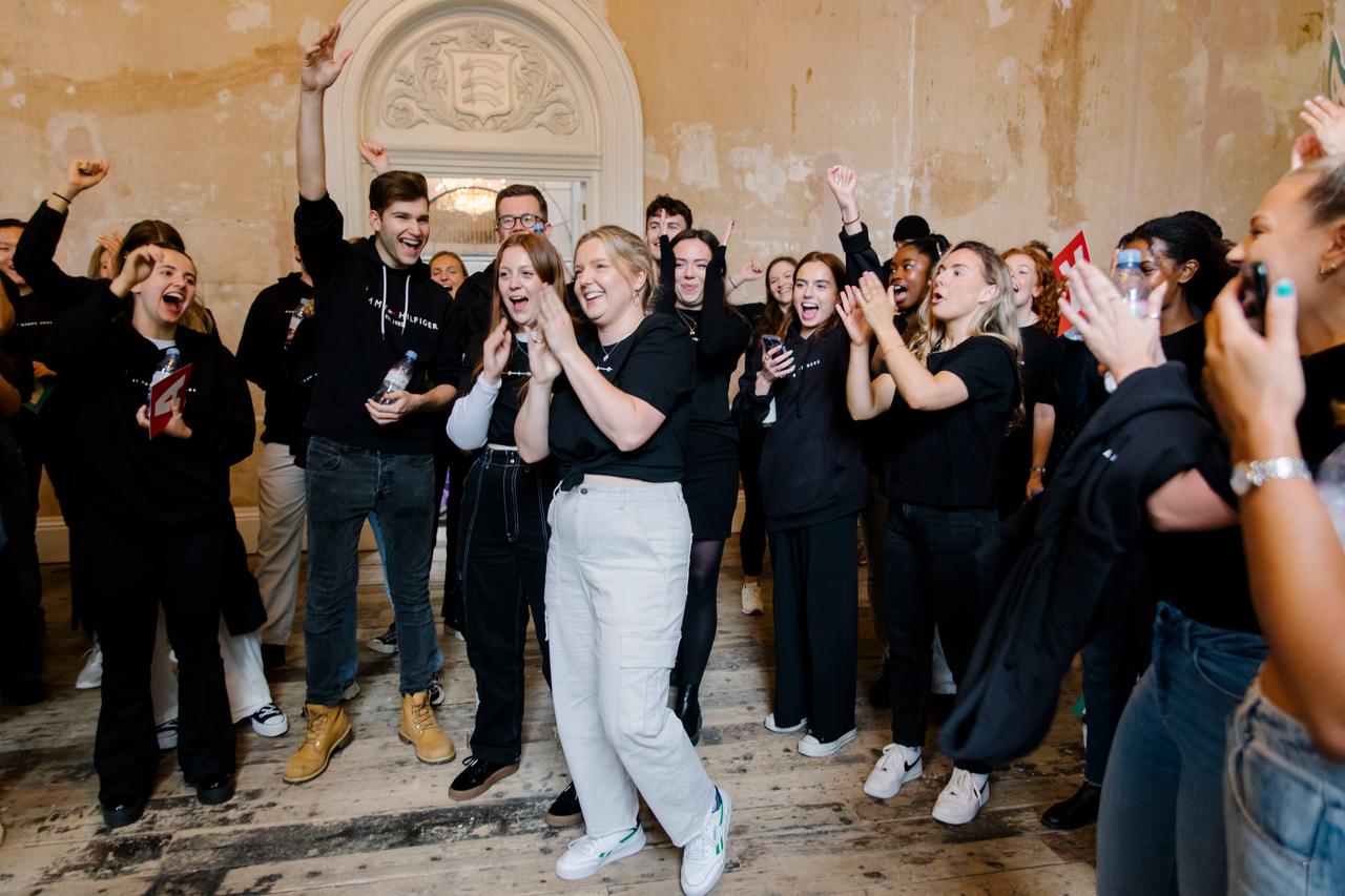Large group of colleagues cheering during an event
