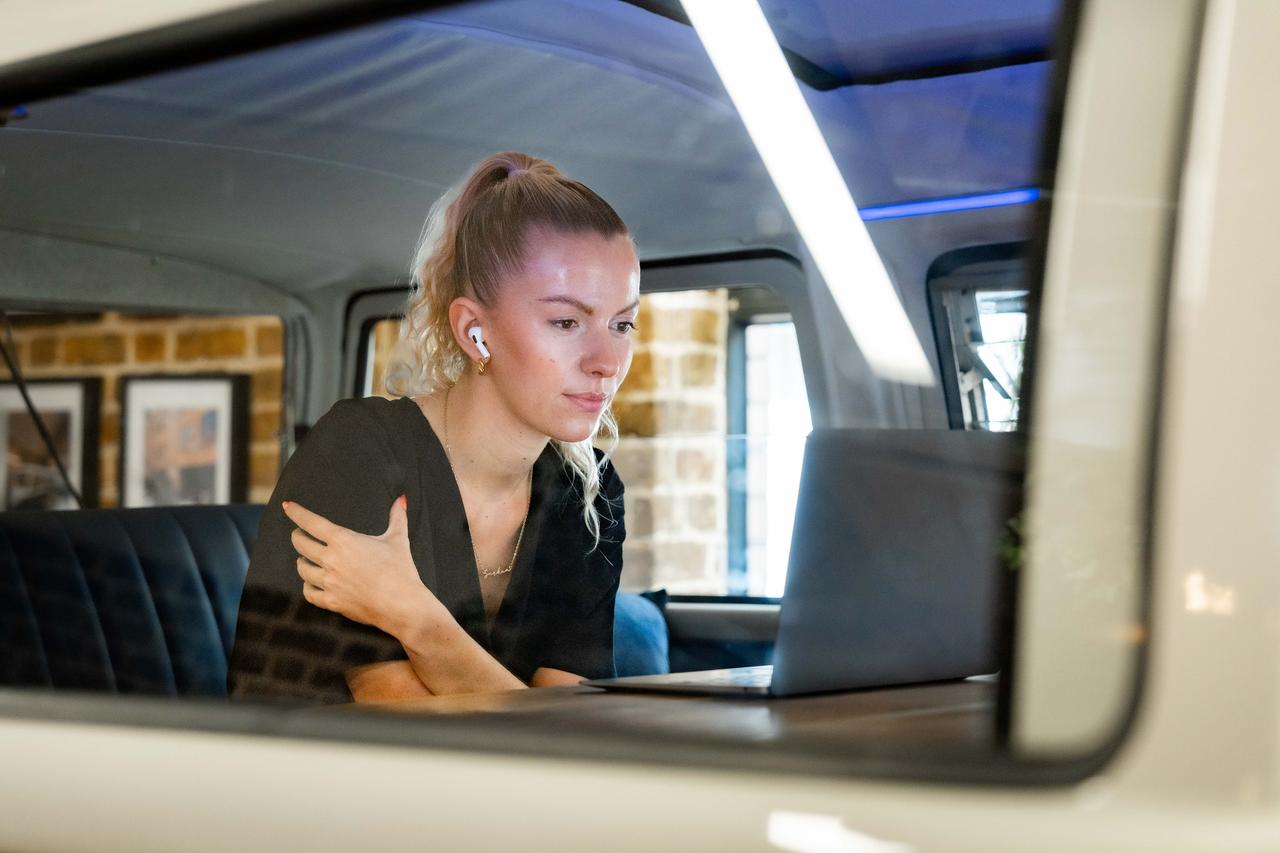 Girl working in campervan