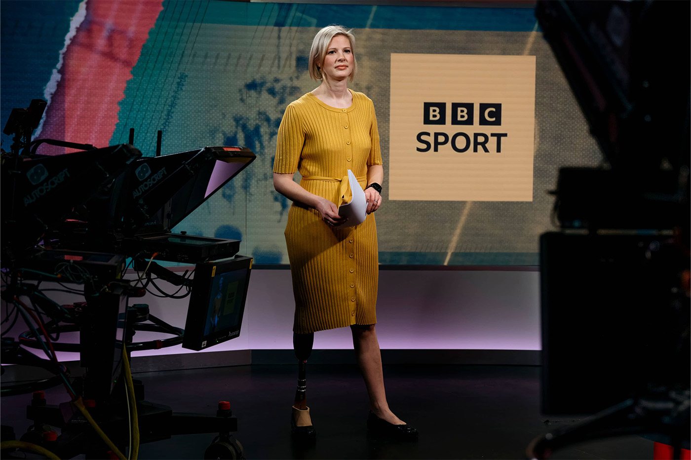 Woman with prosthetic leg presents the sports news