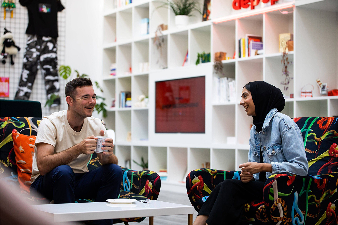 man and woman drinking tea in trendy office