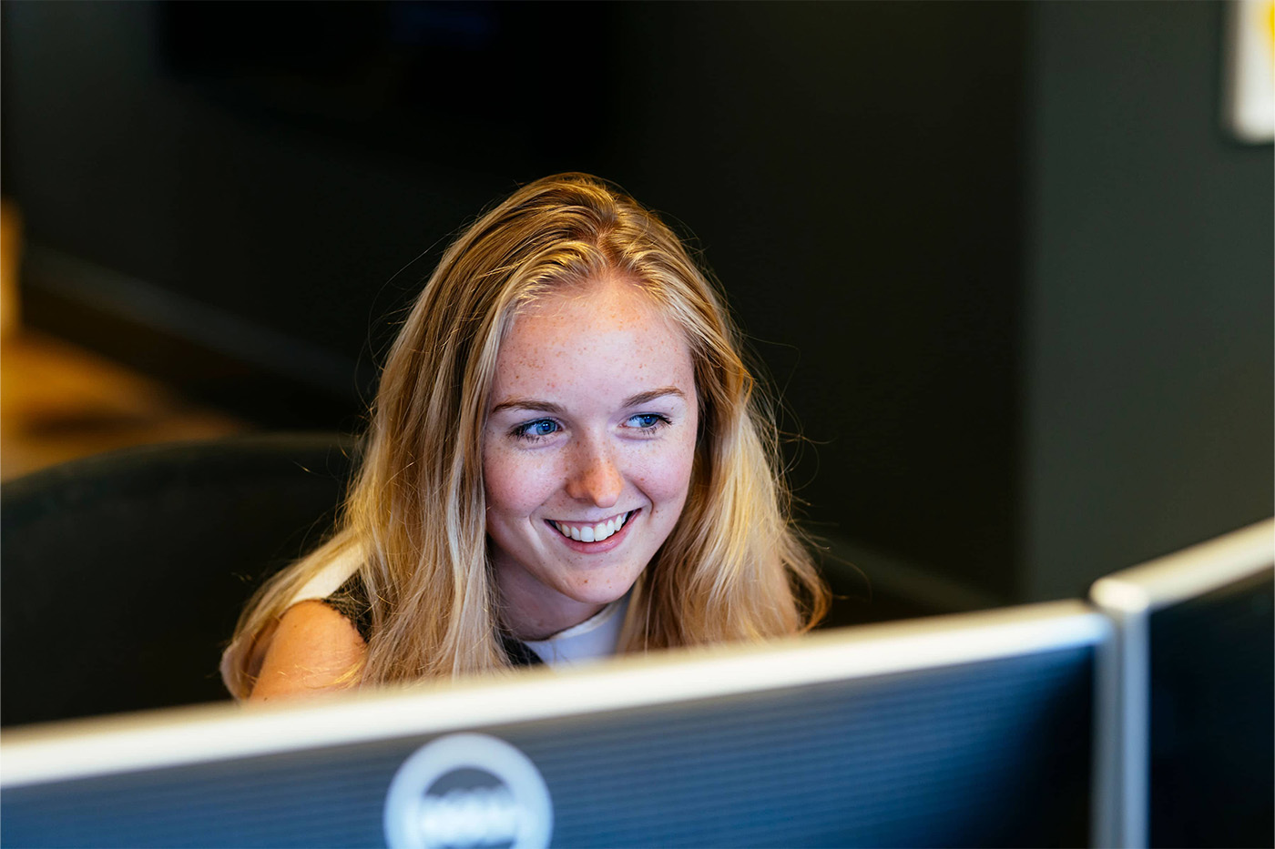 Woman smiling at computer