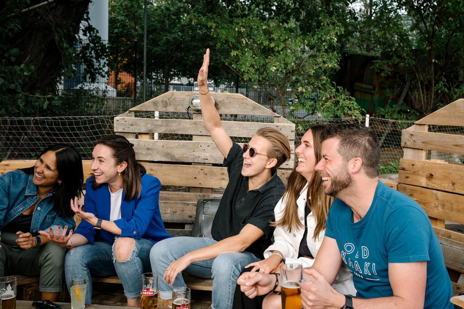 Friendly colleagues relaxing after work with beers