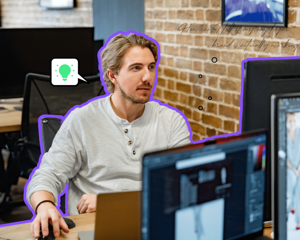 Man working at large computer at desk