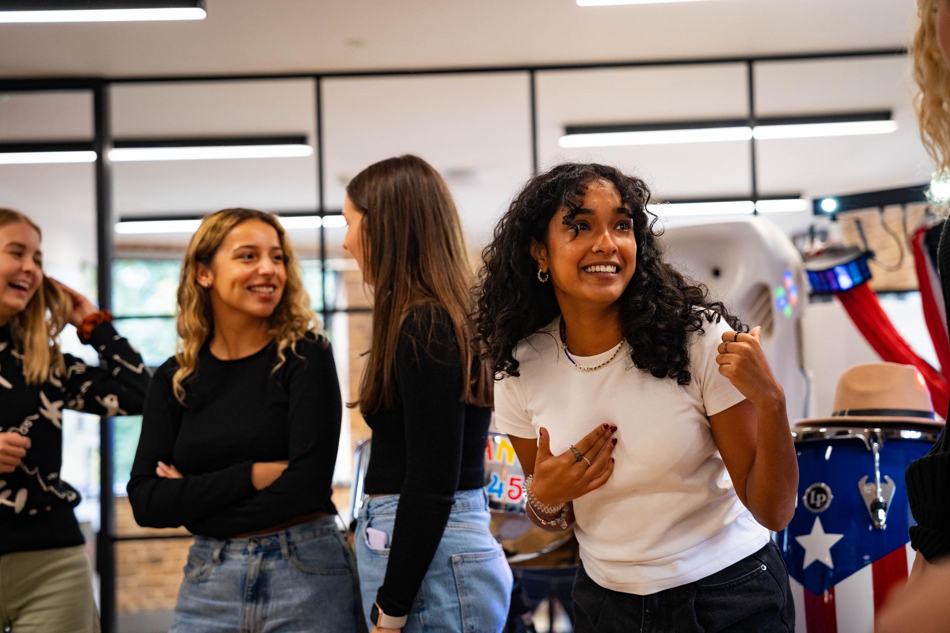 Young women smiling in a line during a Black History Month celebration