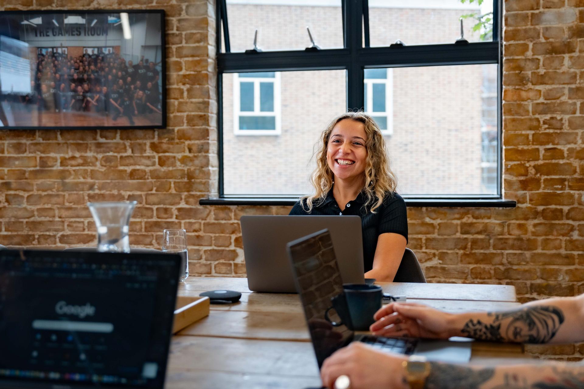 Young woman laughing during a meeting