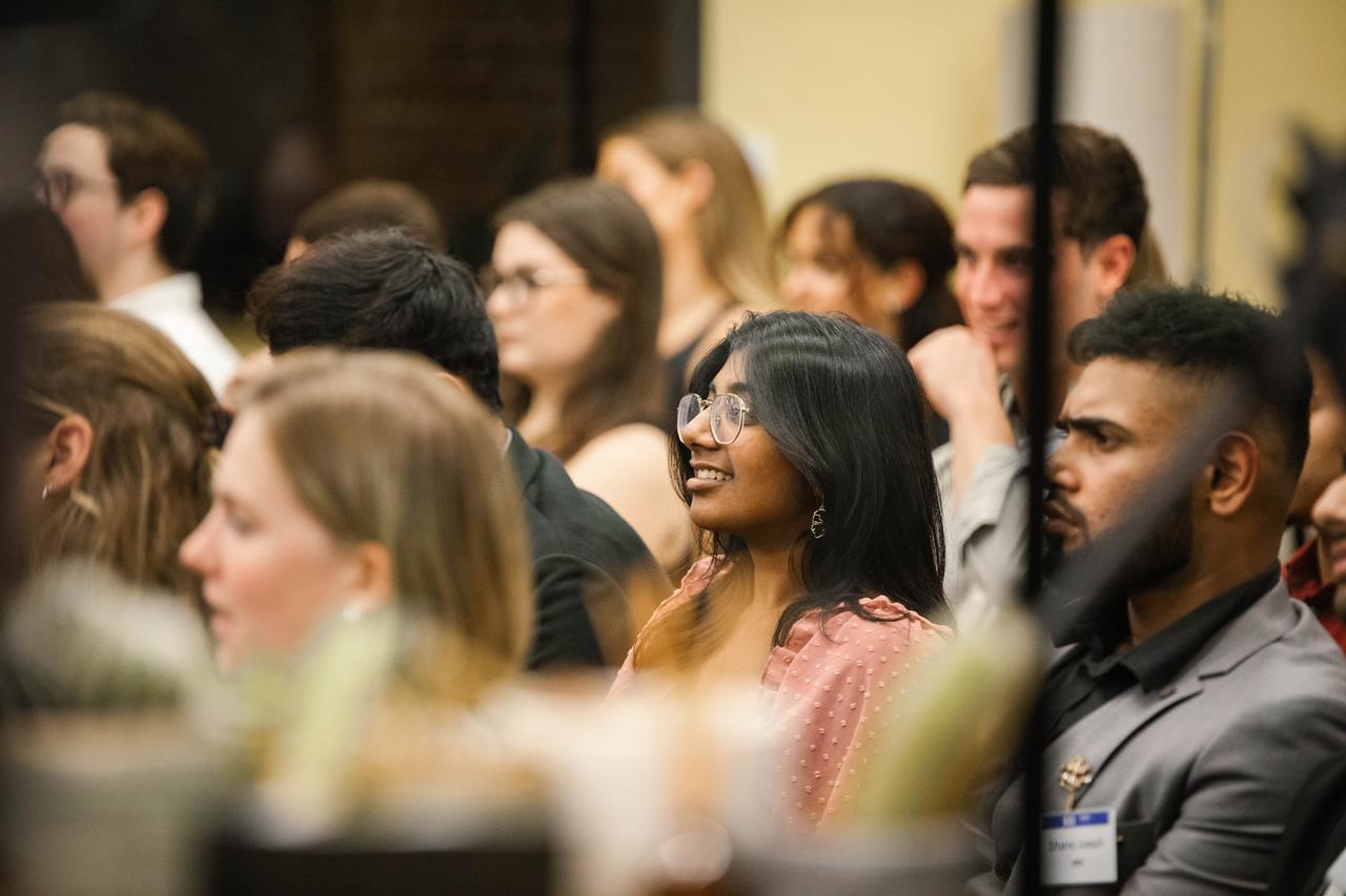 Crowd of diverse students listening to a panel event