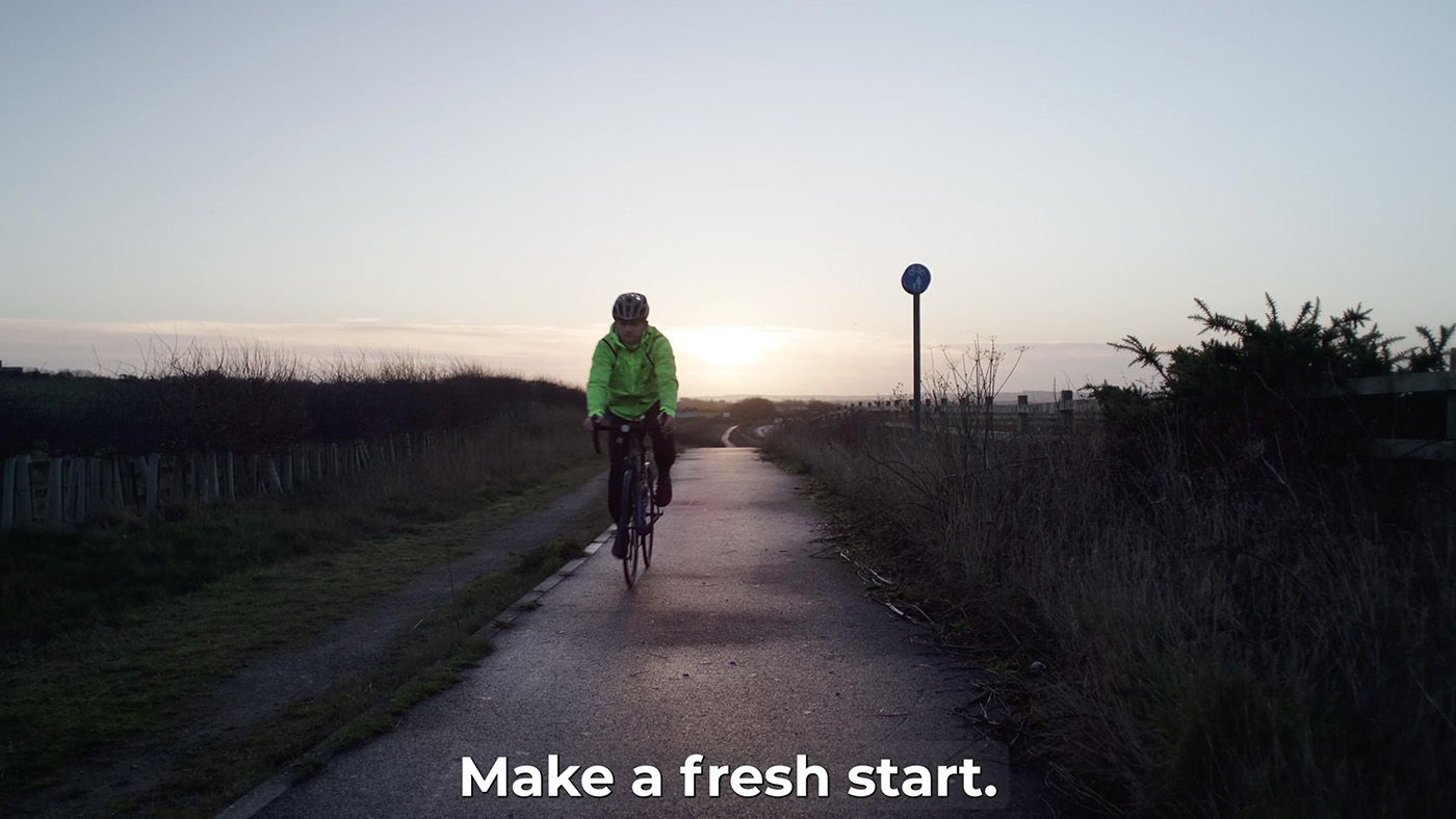 Still from McCain video of man riding a bicycle