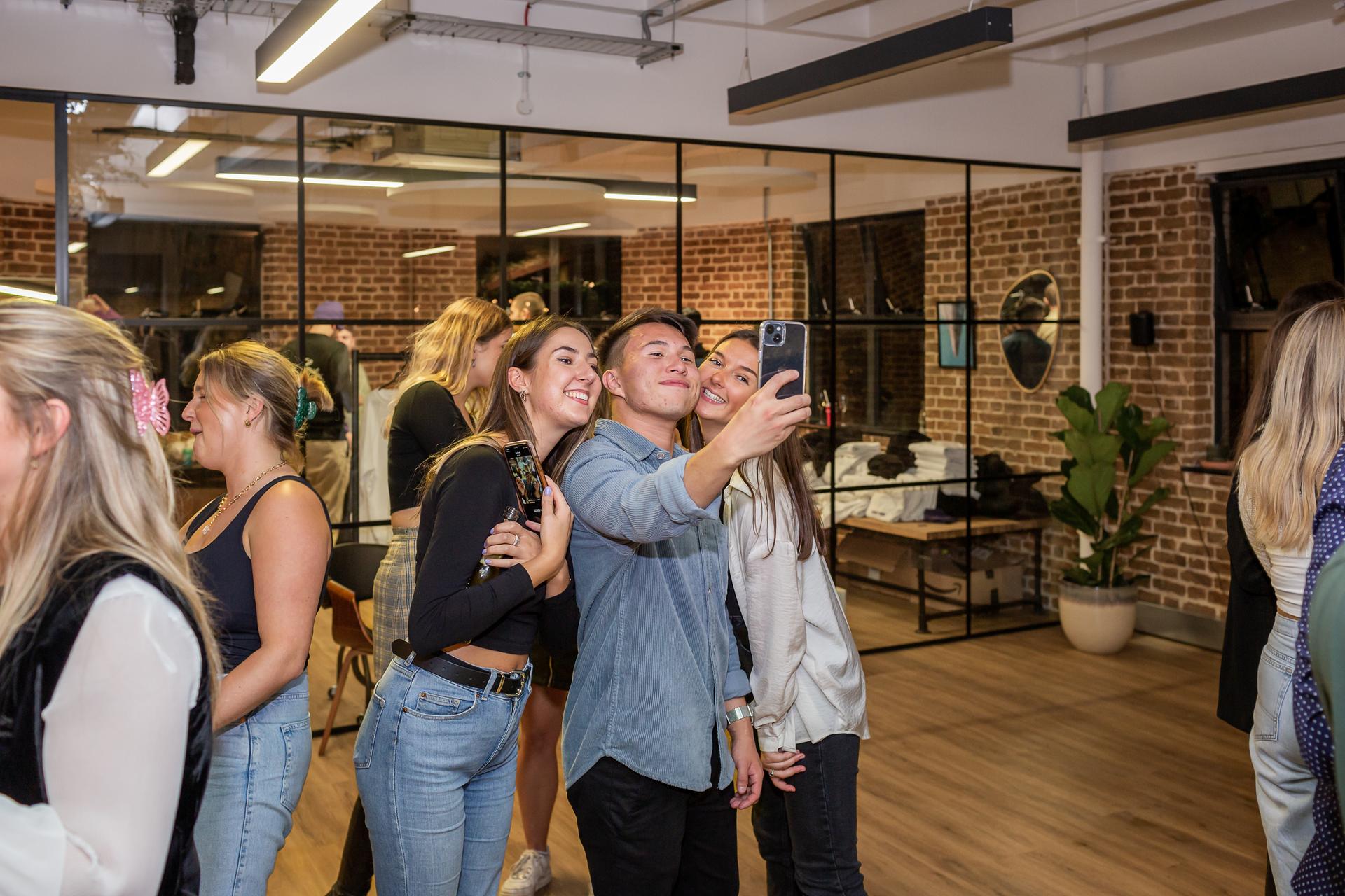 Three Gen-Z colleagues taking a selfie