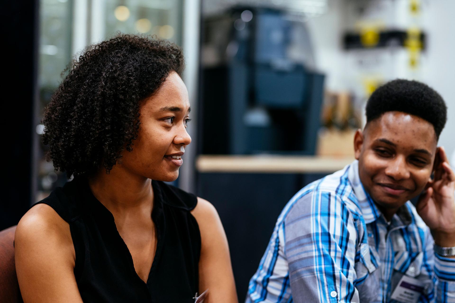 Two students listening to a speaker