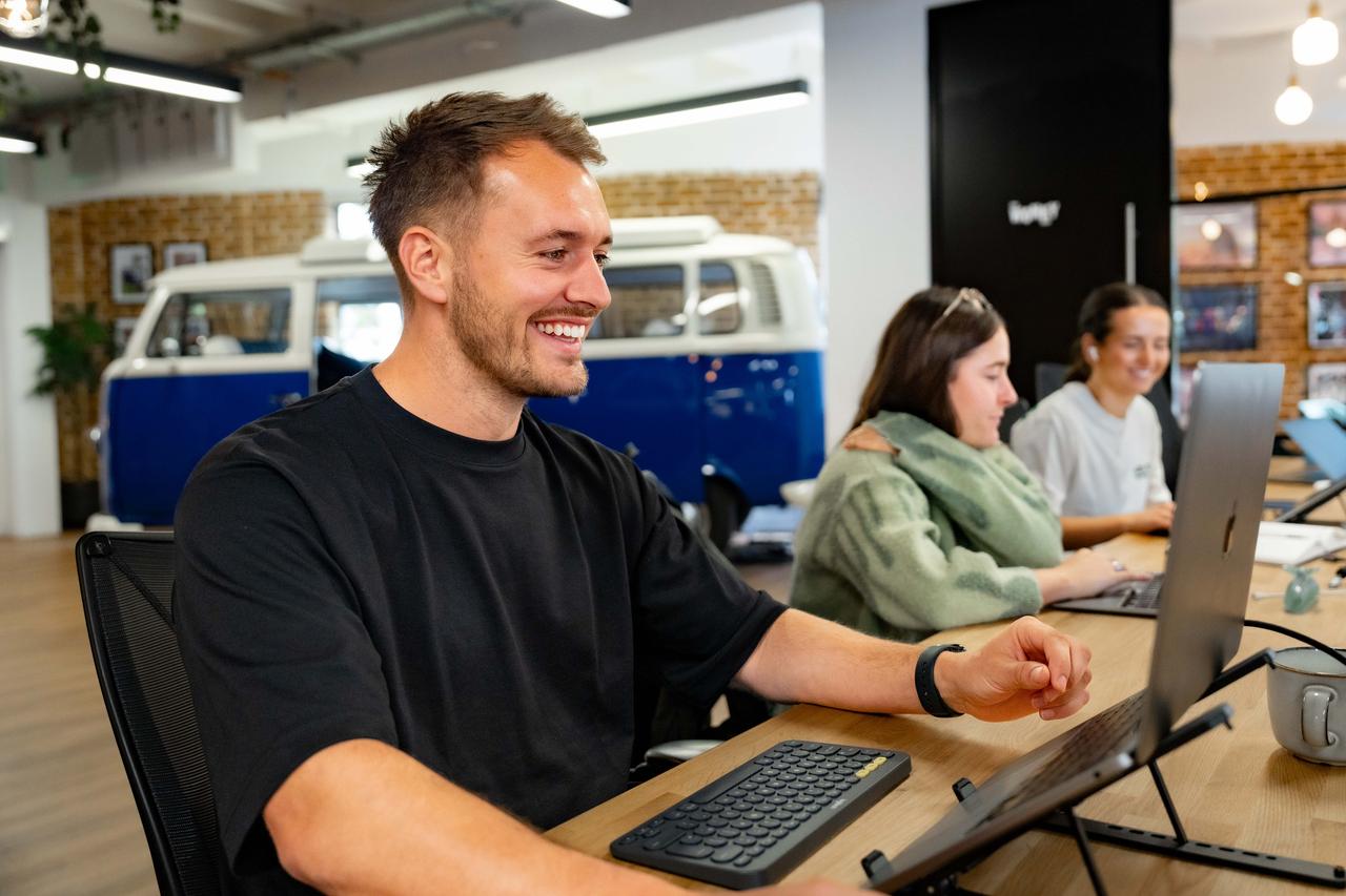 Guy on laptop smiling