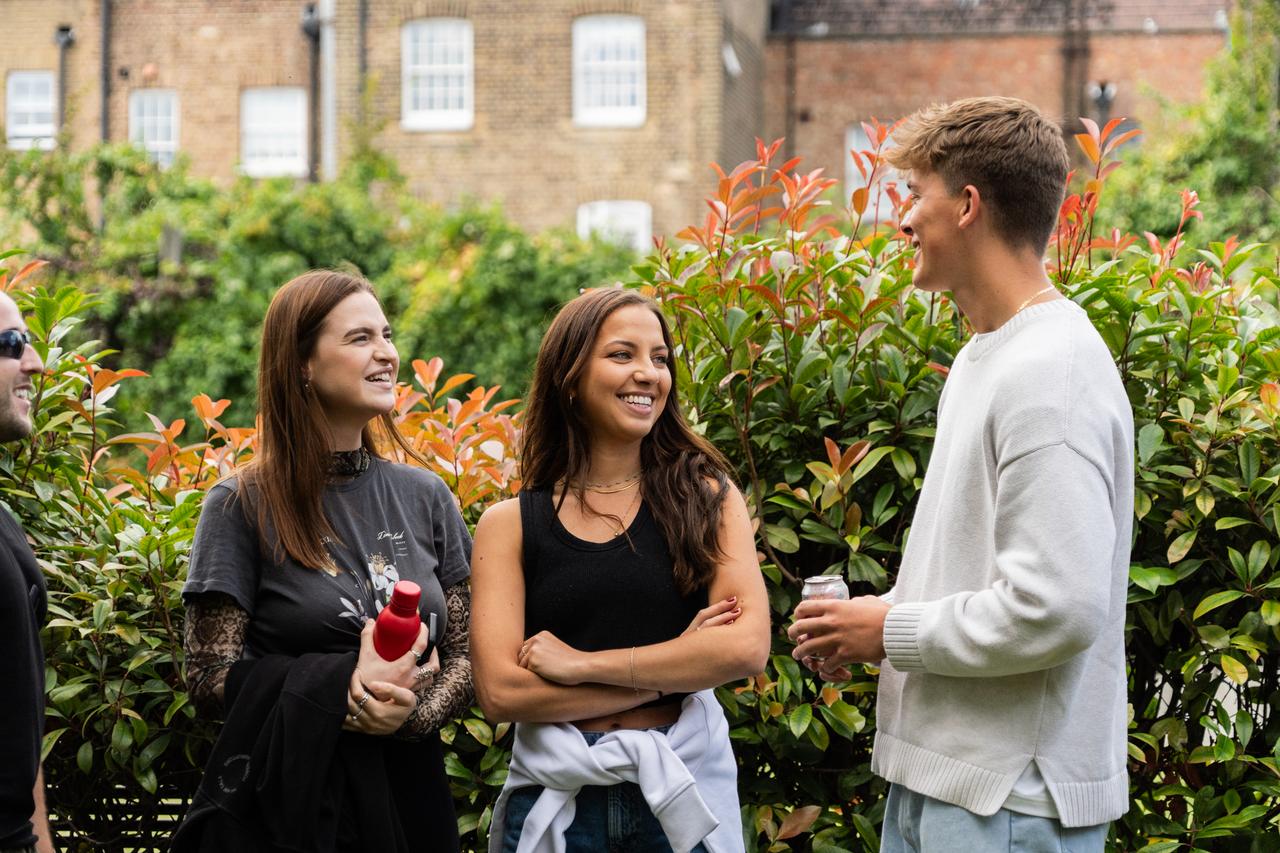 Three people smiling