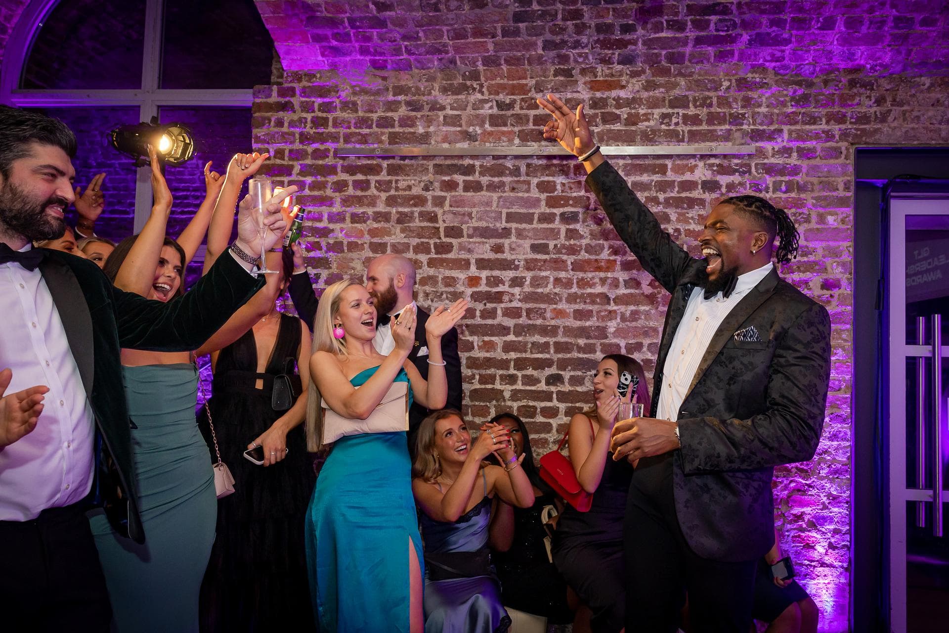 Man with his hand in the air to crowd