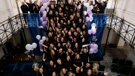 Wiser people standing together on a staircase with balloons