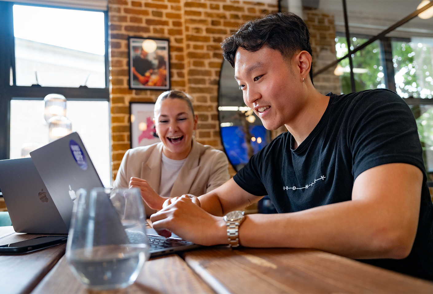 Image of male and female colleagues working over a laptop