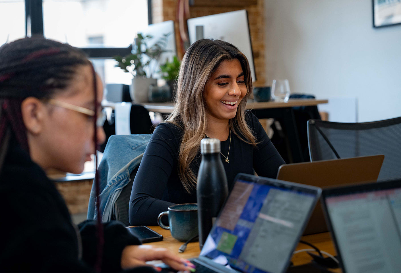 Image of young smiling woman in a vibrant office