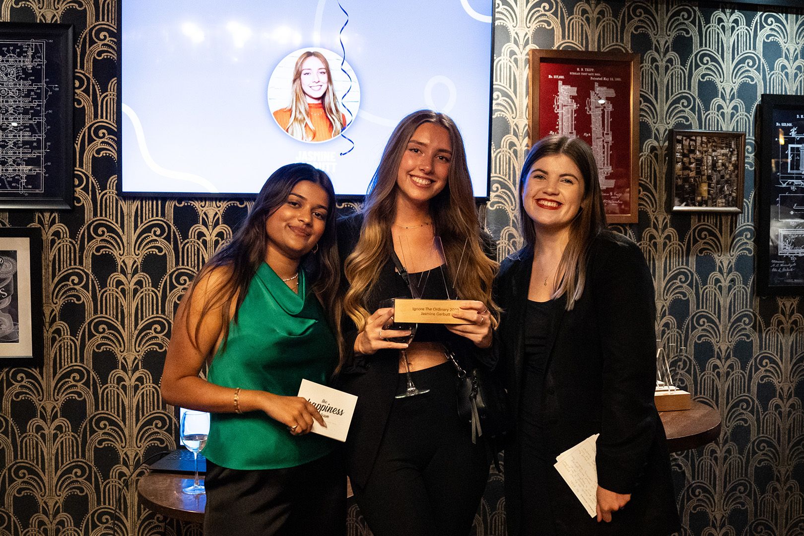 Image of three women celebrating at an awards event