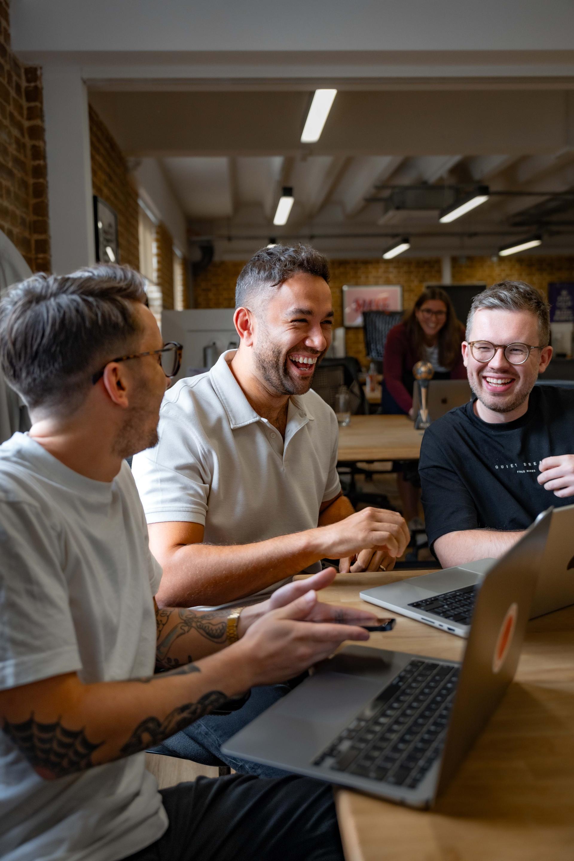 Image of three male colleagues laughing