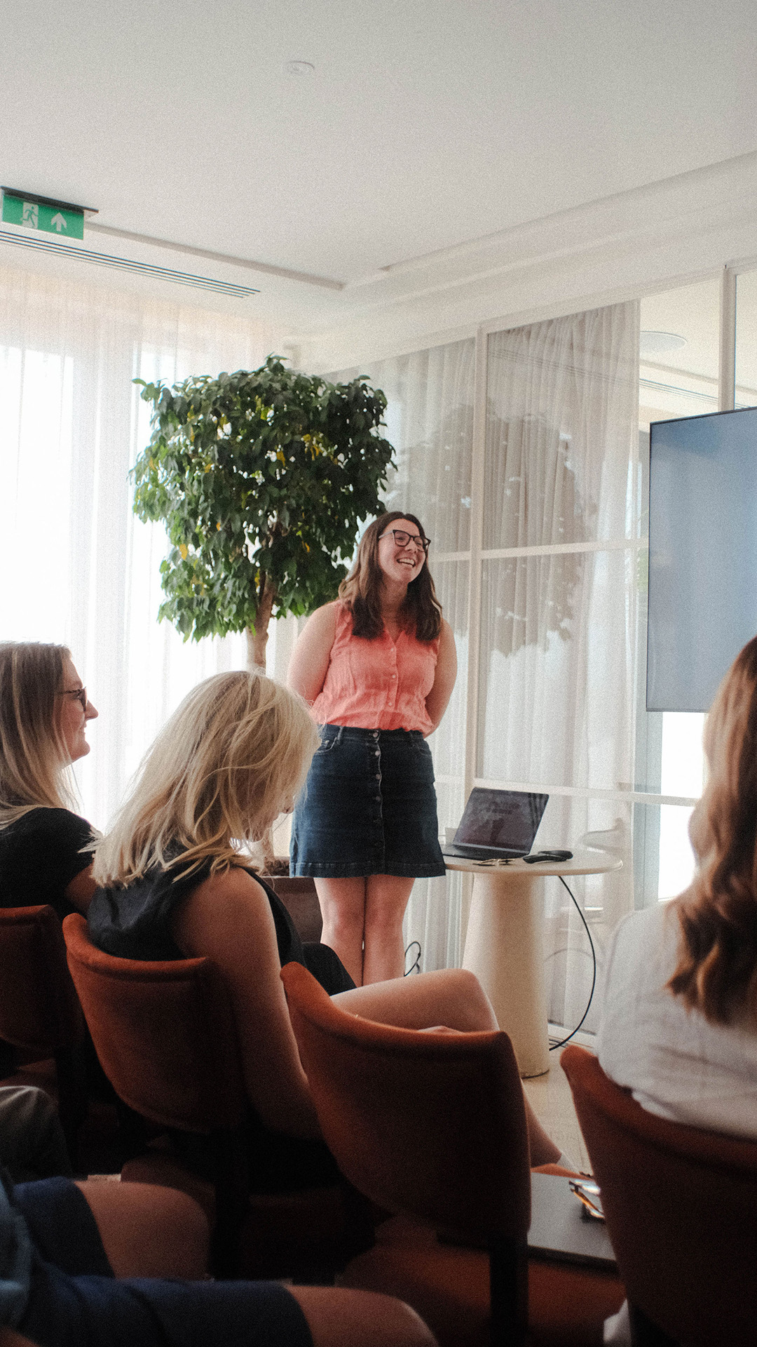 smiling woman delivering a presentation