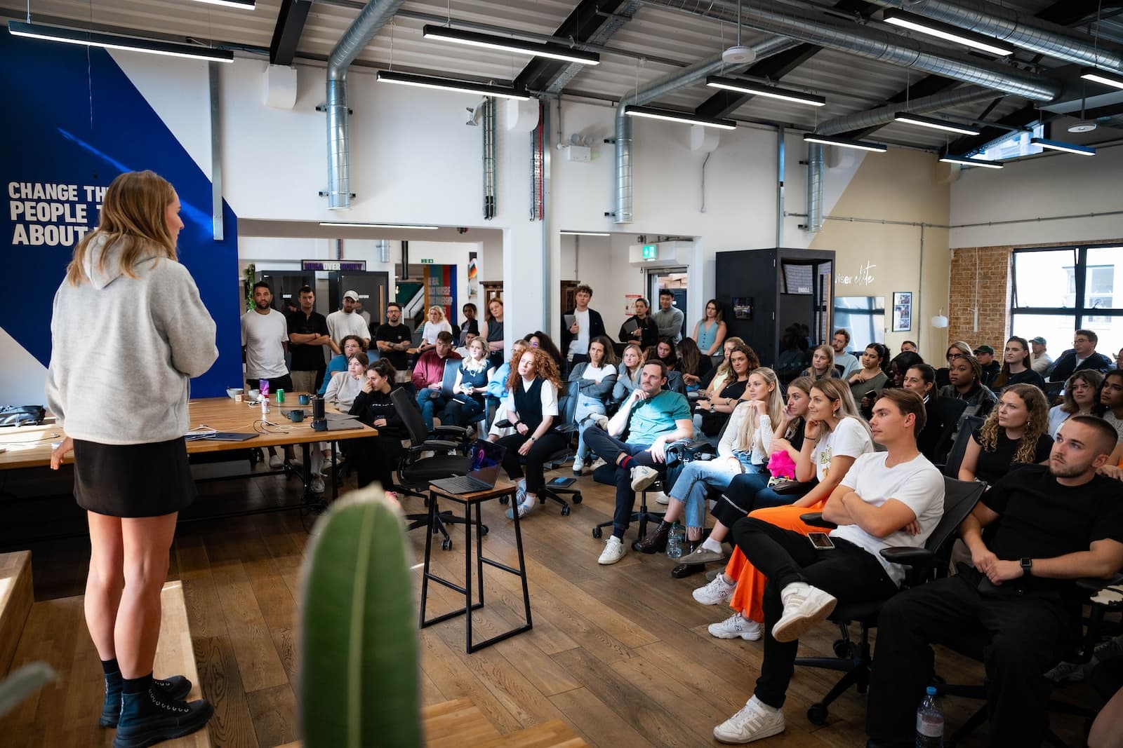 Wiser employees looking at Wiser's COO talk on the stage.