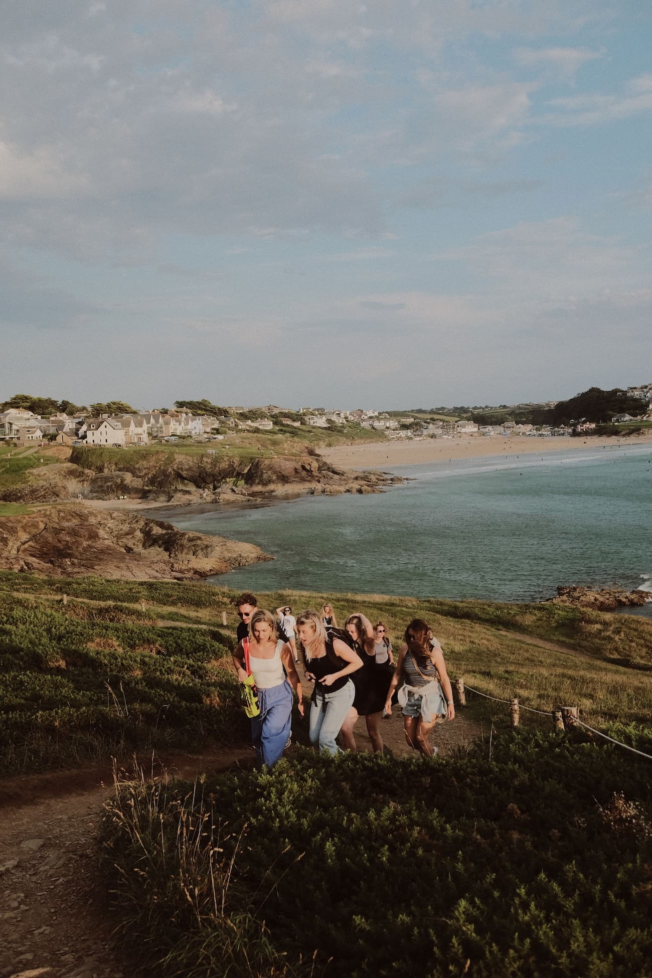 Wiser employees hiking at the coast with the sea and beach in the background.