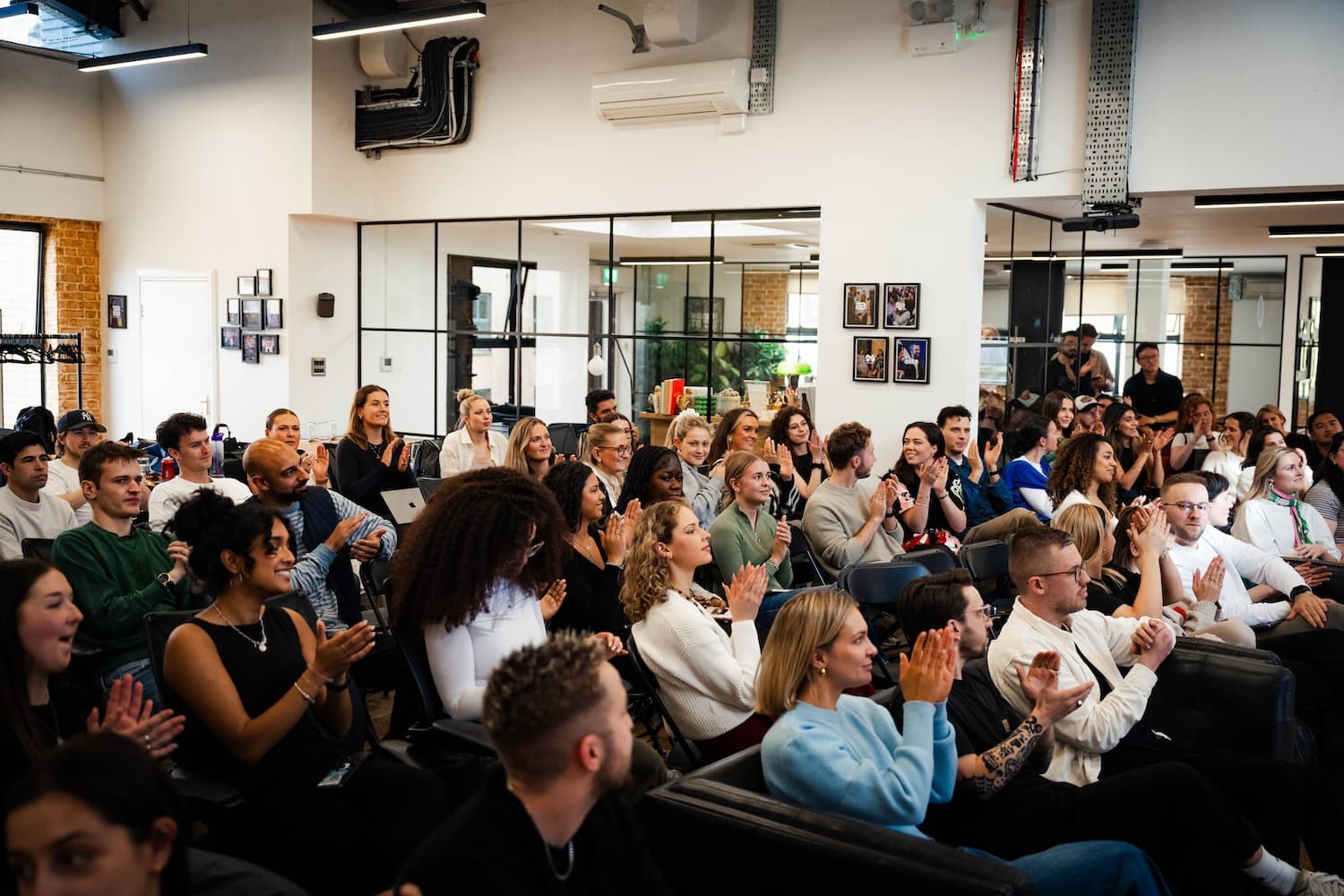 Wiser employees sitting applauding.