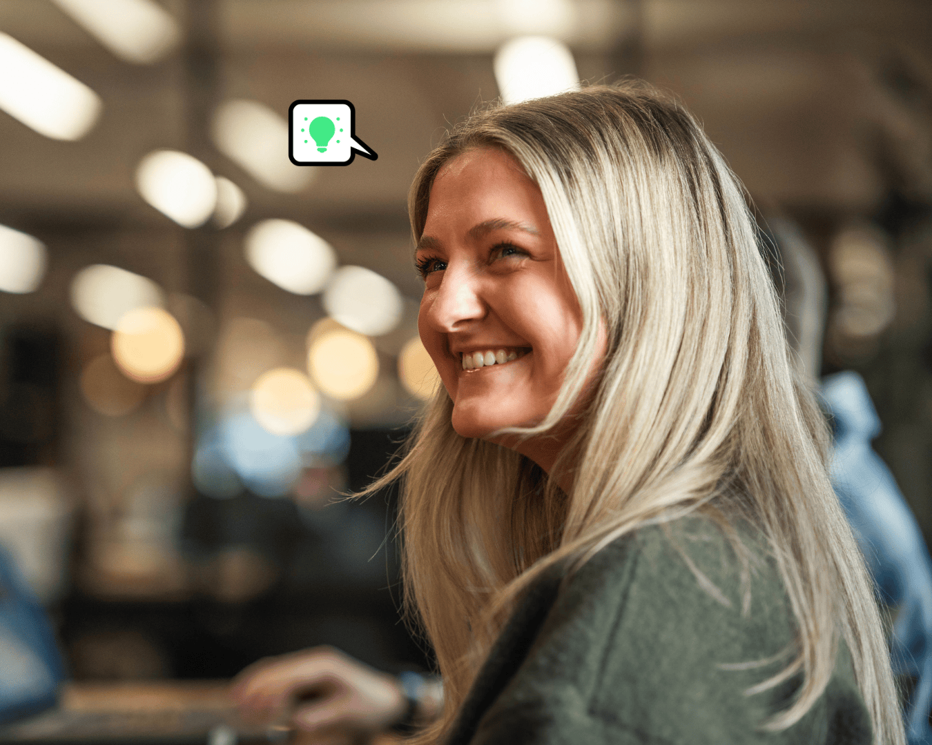 photo of blonde female smiling in a green top