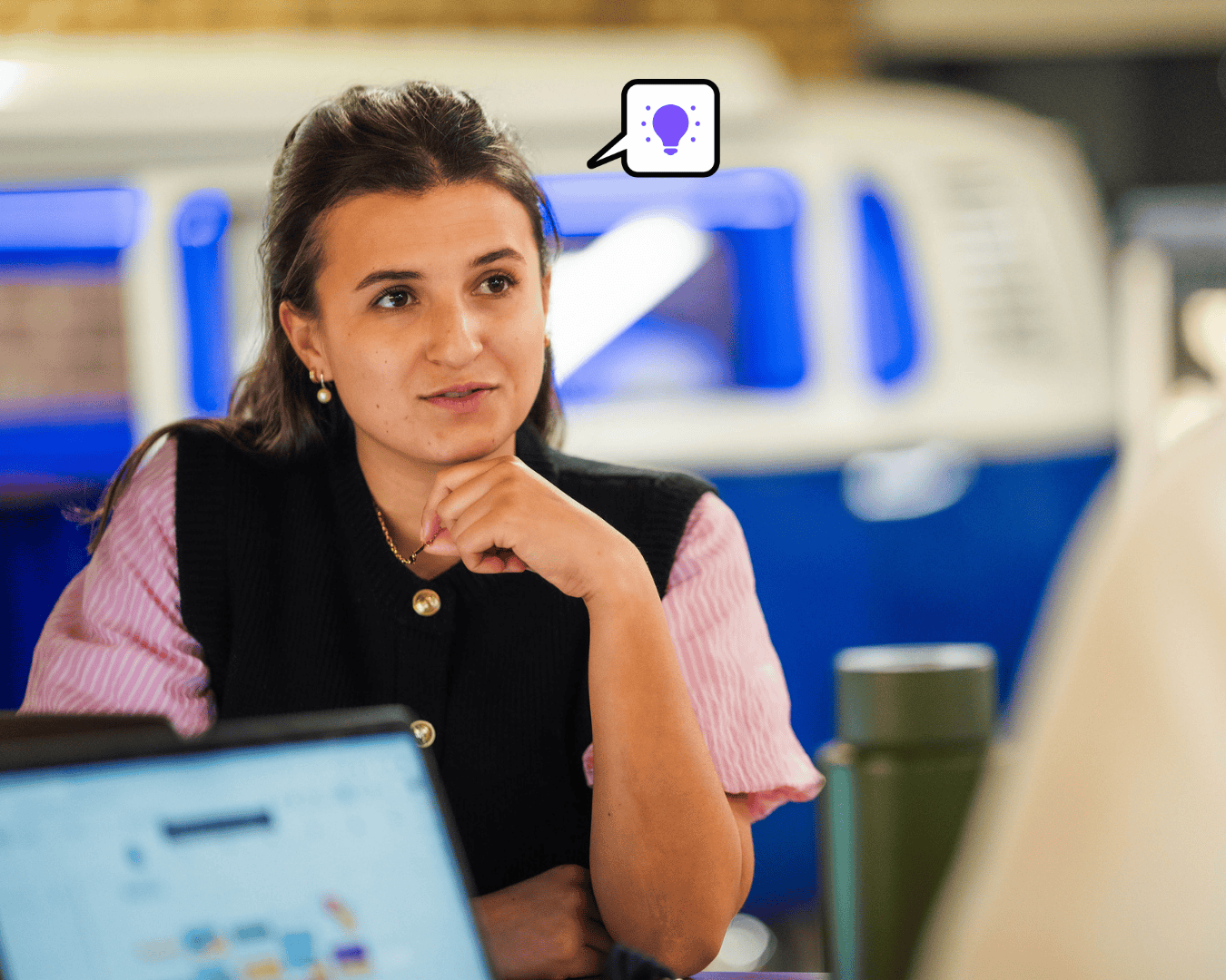 photo of female in a meeting talking to someone in a pint and blue top
