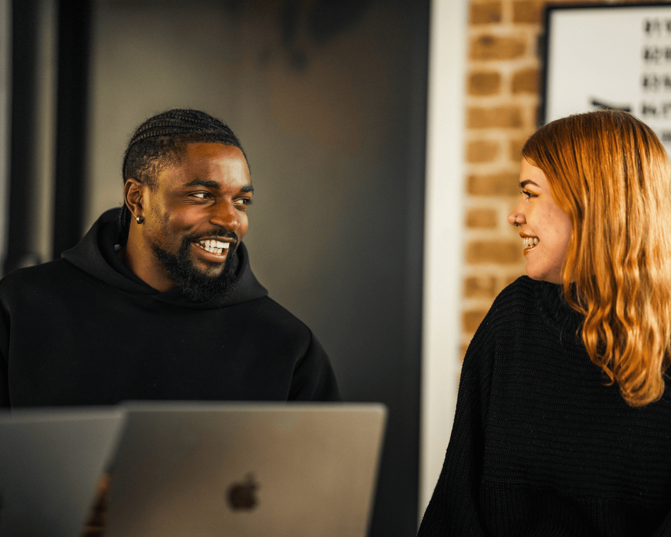 Photo of key accounts team, male and female laughing at each other in the office