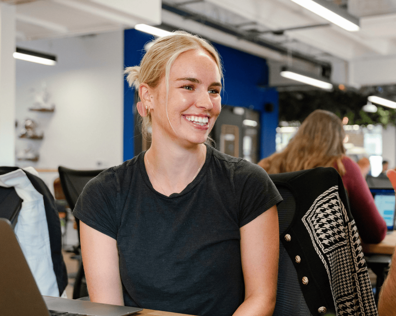 Photo of blonde female in a black tshirt smiling