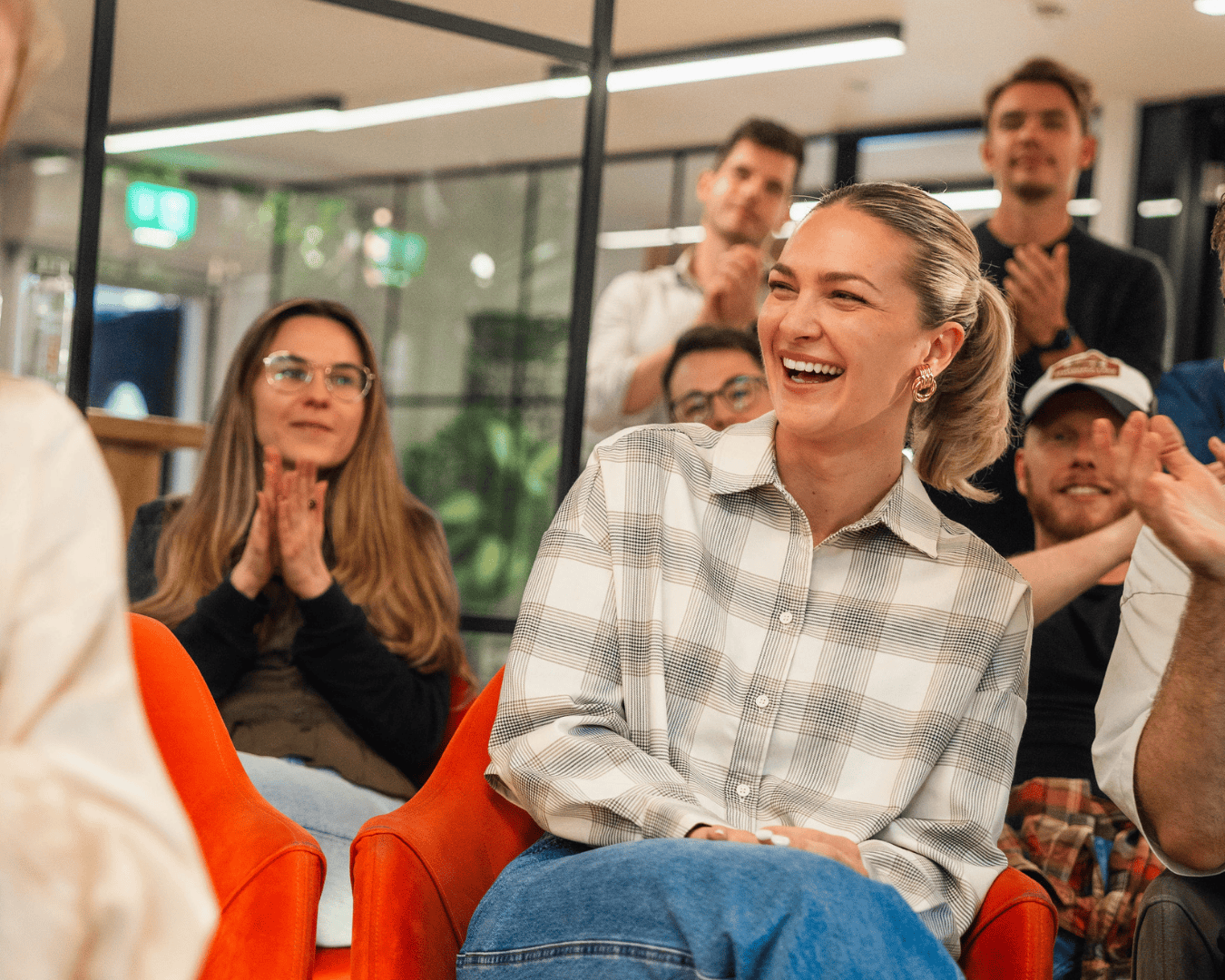 Photo of female with blonde hair in a shirt laughing