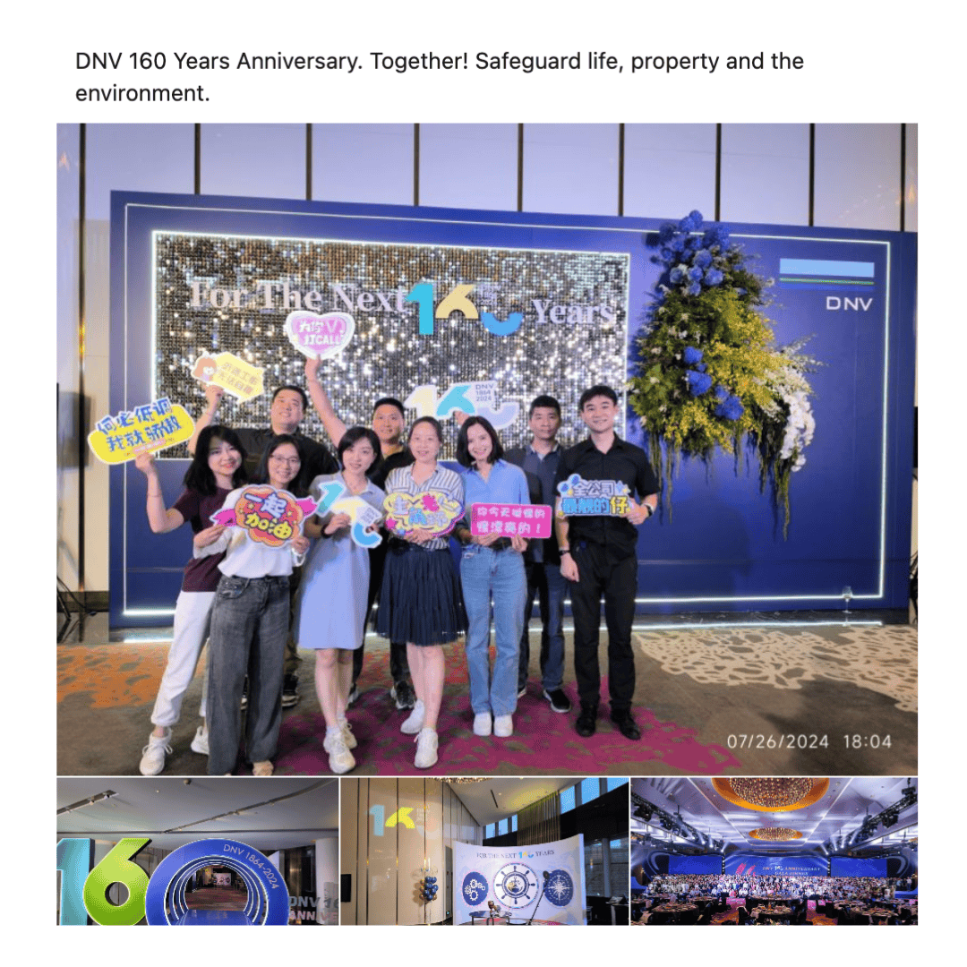 A diverse group of DNV employees—men and women of East Asian descent—pose smiling in front of a glittery “160 Years” display, holding colourful signs at a global anniversary event. #LifeAtDNV