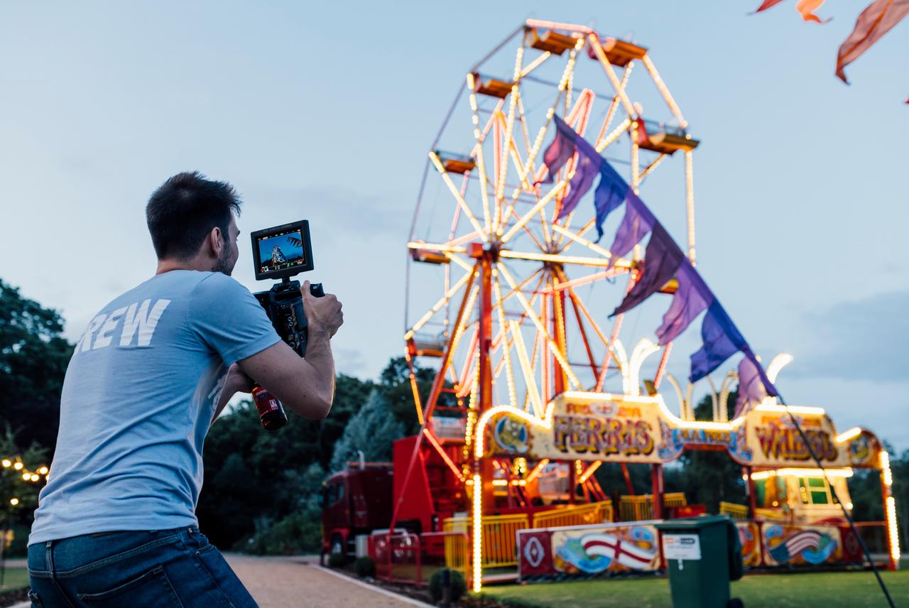 Videographer captures colourful ferris wheel at dusk for creative agency campaign, showcasing Wiser’s vibrant brand storytelling and visual content expertise as a leading UK brand agency team.