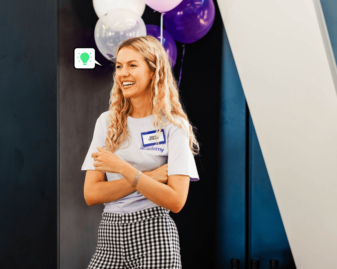 photo of female with blonde curly hair presenting on stage