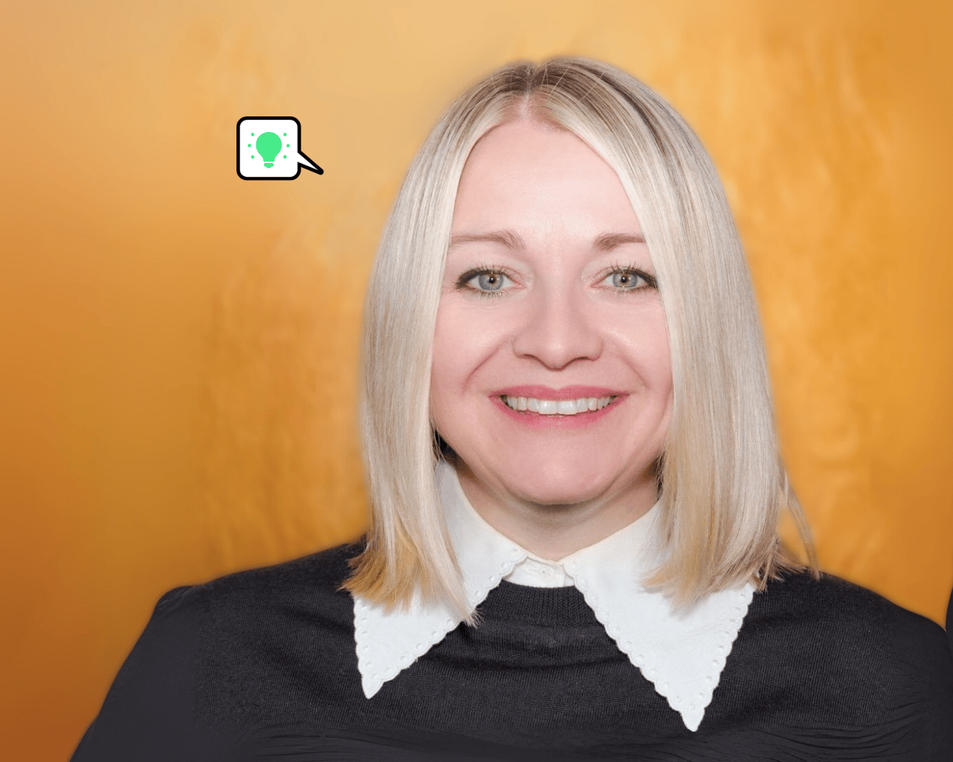 Photo of female with blonde hair smiling with a gold background