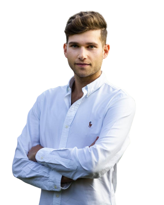 Tall white male with medium brown hair has a calm and confident expression, wearing a white button up shirt, and has his arms folded