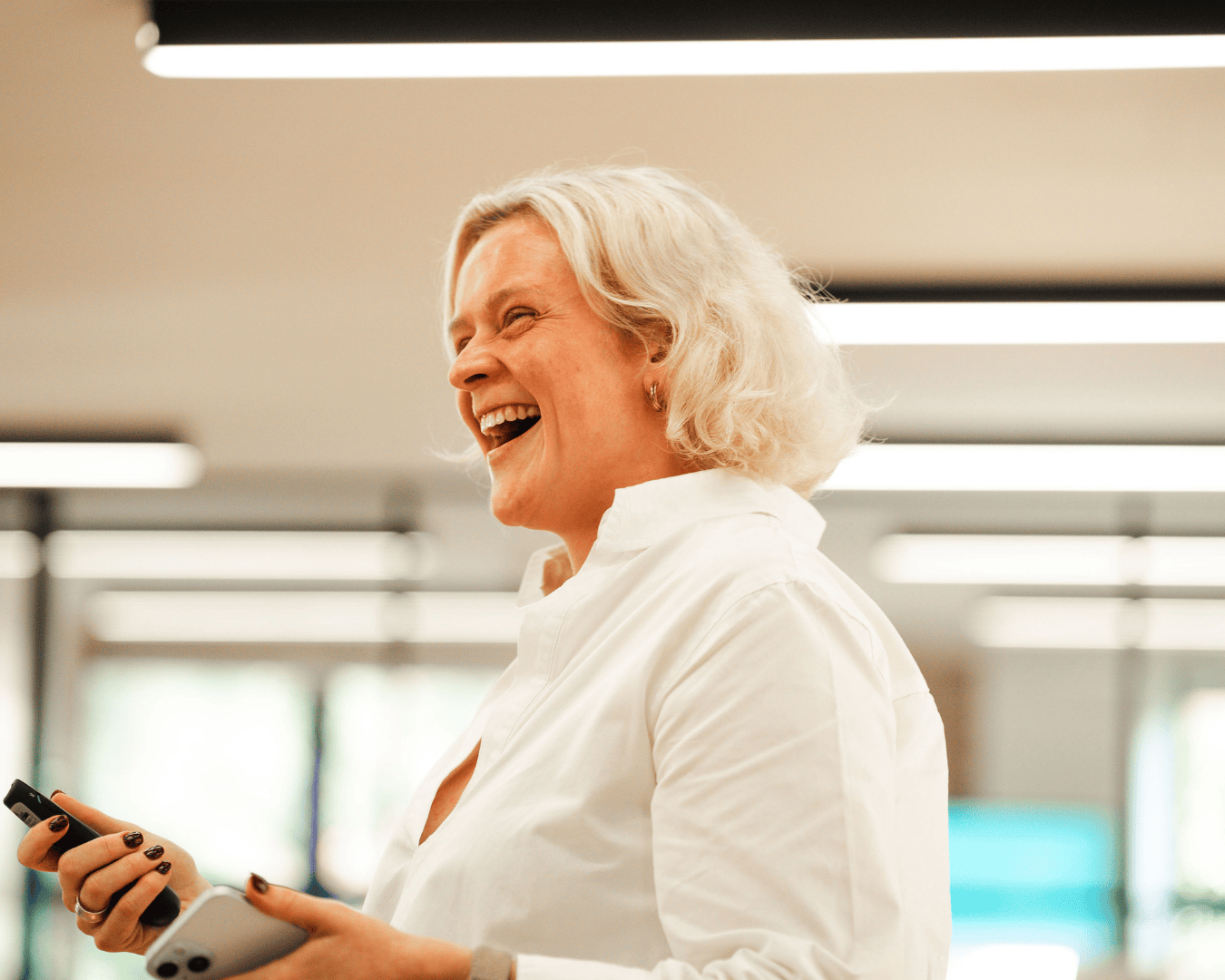 Photo of female with blonde hair and a white shirt smiling
