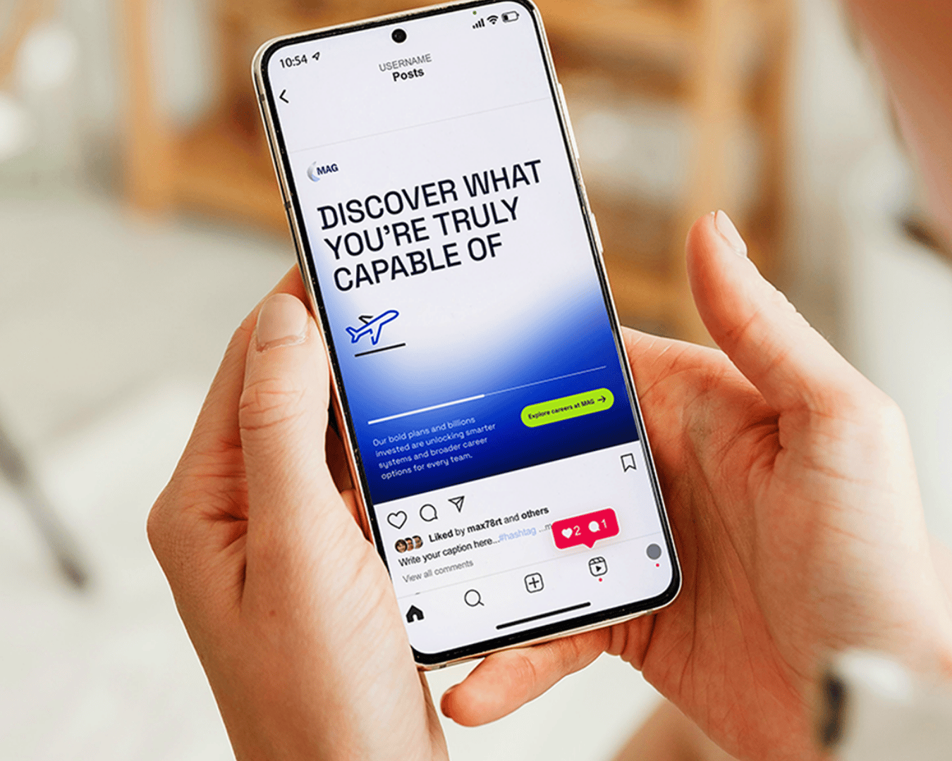 A person holds a smartphone displaying an inspirational Instagram post that reads, "Discover what you're truly capable of," with an airplane icon.
