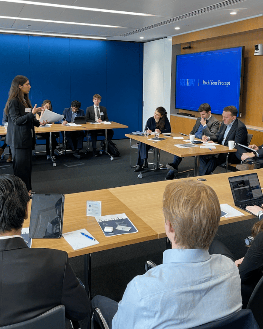 Photo of someone presenting to a panel in an office