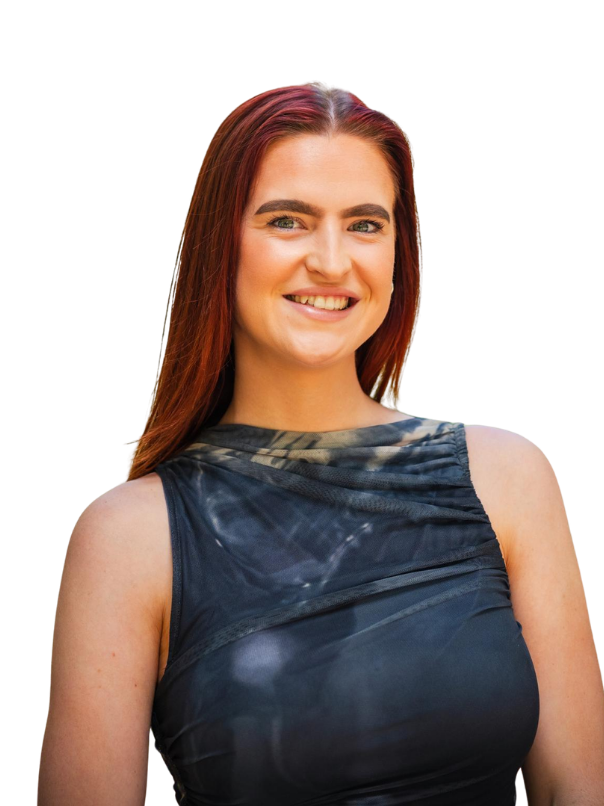 Photo of female with red hair smiling at in a grey top