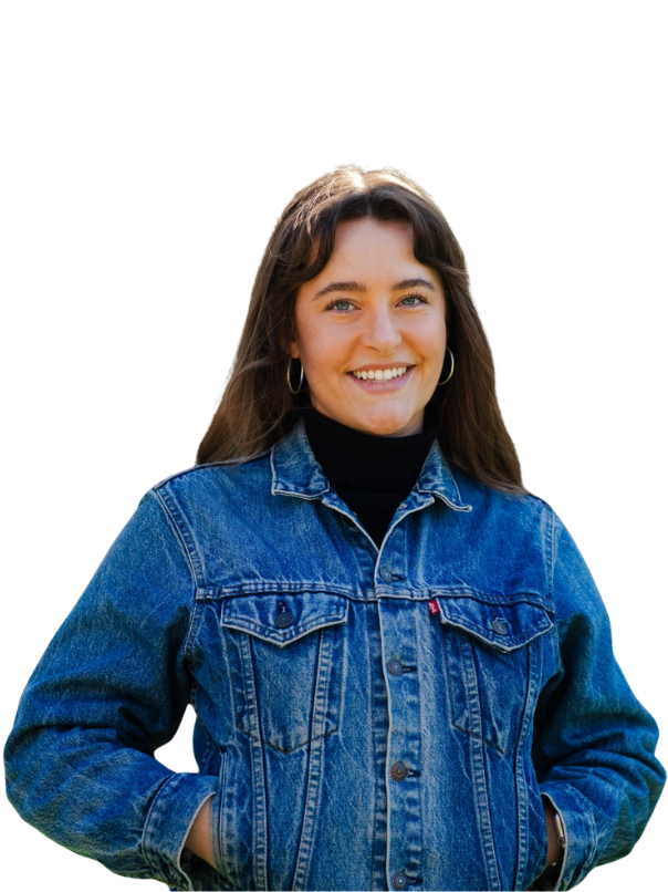 Photo of a female with brown hair smiling in a denim jacket