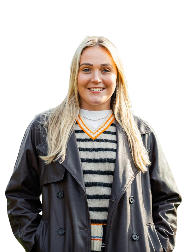 photo of female with blonde hair smiling, wearing a leather jacket